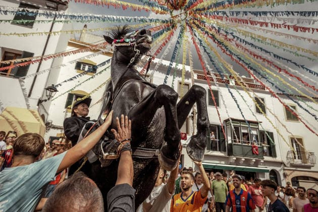 August 24, 2026, Ferreries, Menorca Balearic Islands, Spain: A caixer, or horse rider, rears his horse amid a cheering crowd during the traditional Jaleo at the Sant Bartomeu Festival in Ferreries. Ferreries Spain  - ZUMAo105 20260824_fap_o105_001 Copyright: xMatthiasxOesterlex