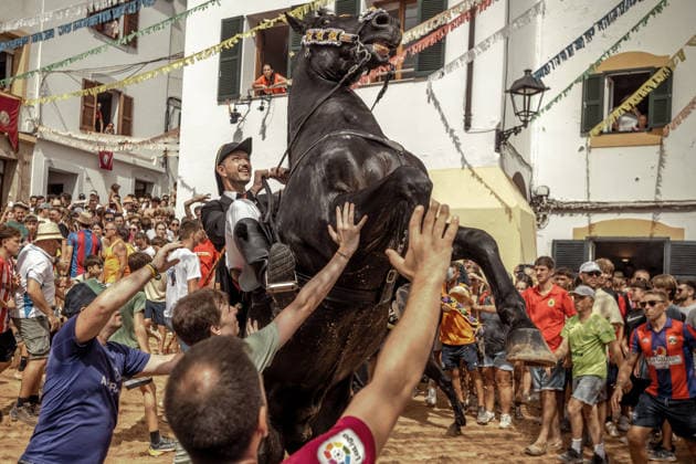 August 24, 2026, Ferreries, Menorca Balearic Islands, Spain: A caixer, or horse rider, rears his horse amid a cheering crowd during the traditional Jaleo at the Sant Bartomeu Festival in Ferreries. Ferreries Spain  - ZUMAo105 20260824_fap_o105_003 Copyright: xMatthiasxOesterlex