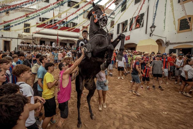 August 24, 2026, Ferreries, Menorca Balearic Islands, Spain: A caixer, or horse rider, rears his horse amid a cheering crowd during the traditional Jaleo at the Sant Bartomeu Festival in Ferreries. Ferreries Spain - ZUMAo105 20260824_fap_o105_004 Copyright: xMatthiasxOesterlex