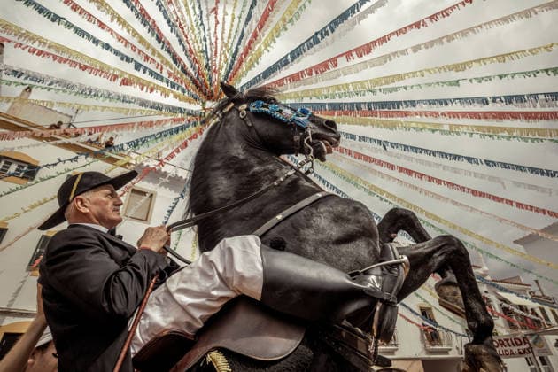 August 24, 2026, Ferreries, Menorca Balearic Islands, Spain: A caixer, or horse rider, rears his horse amid a cheering crowd during the traditional Jaleo at the Sant Bartomeu Festival in Ferreries. Ferreries Spain - ZUMAo105 20260824_fap_o105_005 Copyright: xMatthiasxOesterlex