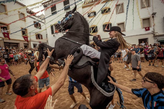 August 24, 2026, Ferreries, Menorca Balearic Islands, Spain: A caixer, or horse rider, rears his horse amid a cheering crowd during the traditional Jaleo at the Sant Bartomeu Festival in Ferreries. Ferreries Spain  - ZUMAo105 20260824_fap_o105_009 Copyright: xMatthiasxOesterlex