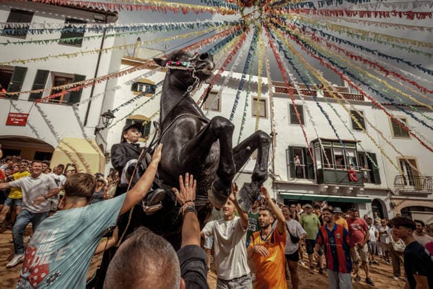 August 24, 2026, Ferreries, Menorca Balearic Islands, Spain: A caixer, or horse rider, rears his horse amid a cheering crowd during the traditional Jaleo at the Sant Bartomeu Festival in Ferreries. Ferreries Spain - ZUMAo105 20260824_fap_o105_008 Copyright: xMatthiasxOesterlex