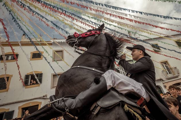 August 24, 2026, Ferreries, Menorca Balearic Islands, Spain: A caixer, or horse rider, rears his horse amid a cheering crowd during the traditional Jaleo at the Sant Bartomeu Festival in Ferreries. Ferreries Spain  - ZUMAo105 20260824_fap_o105_015 Copyright: xMatthiasxOesterlex