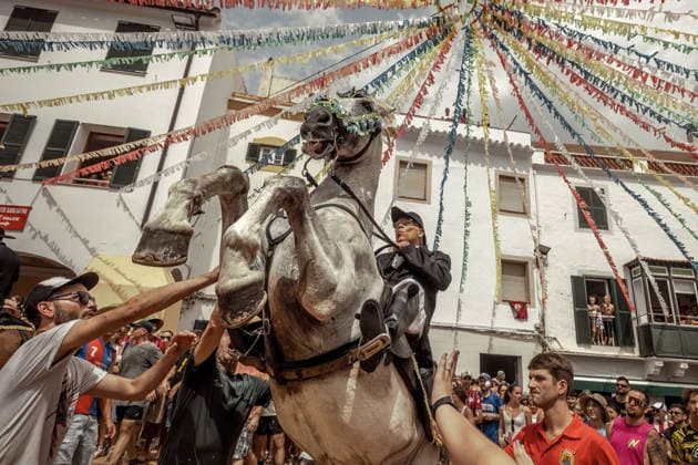 August 24, 2026, Ferreries, Menorca Balearic Islands, Spain: A caixer, or horse rider, rears his horse amid a cheering crowd during the traditional Jaleo at the Sant Bartomeu Festival in Ferreries. Ferreries Spain  - ZUMAo105 20260824_fap_o105_018 Copyright: xMatthiasxOesterlex