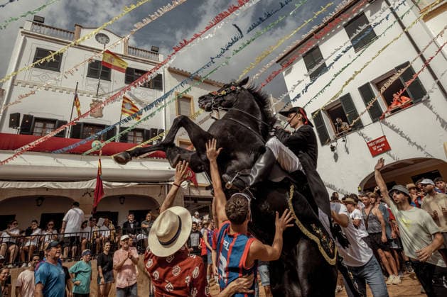 August 24, 2026, Ferreries, Menorca Balearic Islands, Spain: A caixer, or horse rider, rears his horse amid a cheering crowd during the traditional Jaleo at the Sant Bartomeu Festival in Ferreries. Ferreries Spain - ZUMAo105 20260824_fap_o105_011 Copyright: xMatthiasxOesterlex