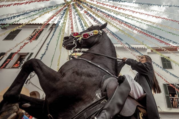 August 24, 2026, Ferreries, Menorca Balearic Islands, Spain: A caixer, or horse rider, rears his horse amid a cheering crowd during the traditional Jaleo at the Sant Bartomeu Festival in Ferreries. Ferreries Spain - ZUMAo105 20260824_fap_o105_014 Copyright: xMatthiasxOesterlex