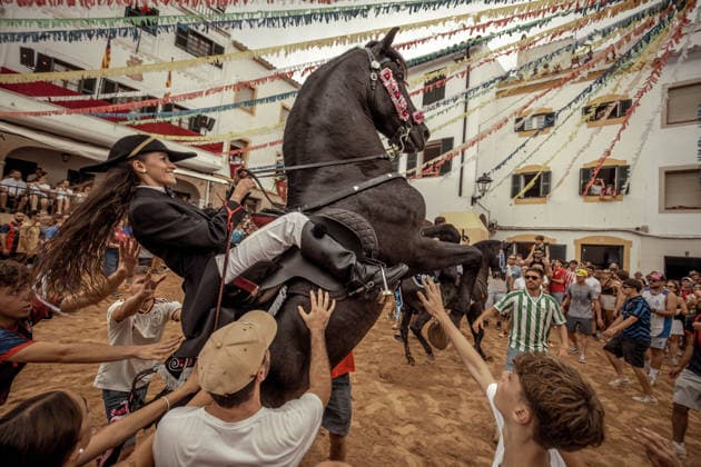 August 24, 2026, Ferreries, Menorca Balearic Islands, Spain: A caixer, or horse rider, rears his horse amid a cheering crowd during the traditional Jaleo at the Sant Bartomeu Festival in Ferreries. Ferreries Spain  - ZUMAo105 20260824_fap_o105_026 Copyright: xMatthiasxOesterlex