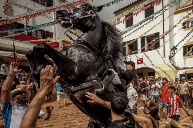 August 24, 2026, Ferreries, Menorca Balearic Islands, Spain: A caixer, or horse rider, rears his horse amid a cheering crowd during the traditional Jaleo at the Sant Bartomeu Festival in Ferreries. Ferreries Spain  - ZUMAo105 20260824_fap_o105_028 Copyright: xMatthiasxOesterlex