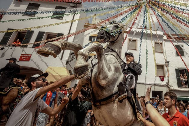August 24, 2026, Ferreries, Menorca Balearic Islands, Spain: A caixer, or horse rider, rears his horse amid a cheering crowd during the traditional Jaleo at the Sant Bartomeu Festival in Ferreries. Ferreries Spain - ZUMAo105 20260824_fap_o105_020 Copyright: xMatthiasxOesterlex