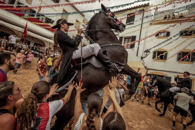 August 24, 2026, Ferreries, Menorca Balearic Islands, Spain: A caixer, or horse rider, rears his horse amid a cheering crowd during the traditional Jaleo at the Sant Bartomeu Festival in Ferreries. Ferreries Spain - ZUMAo105 20260824_fap_o105_017 Copyright: xMatthiasxOesterlex