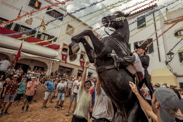 August 24, 2026, Ferreries, Menorca Balearic Islands, Spain: A caixer, or horse rider, rears his horse amid a cheering crowd during the traditional Jaleo at the Sant Bartomeu Festival in Ferreries. Ferreries Spain  - ZUMAo105 20260824_fap_o105_038 Copyright: xMatthiasxOesterlex