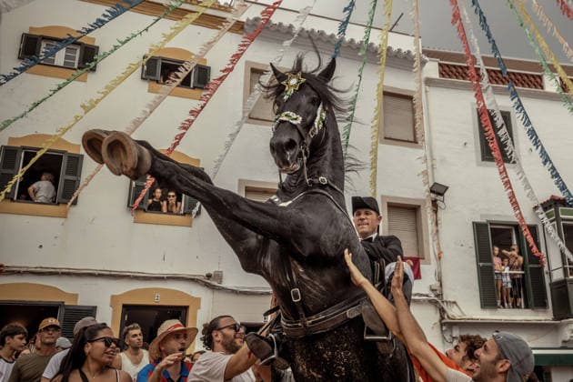 August 24, 2026, Ferreries, Menorca Balearic Islands, Spain: A caixer, or horse rider, rears his horse amid a cheering crowd during the traditional Jaleo at the Sant Bartomeu Festival in Ferreries. Ferreries Spain - ZUMAo105 20260824_fap_o105_019 Copyright: xMatthiasxOesterlex