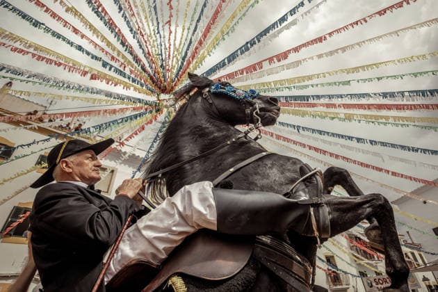 August 24, 2026, Ferreries, Menorca Balearic Islands, Spain: A caixer, or horse rider, rears his horse amid a cheering crowd during the traditional Jaleo at the Sant Bartomeu Festival in Ferreries. Ferreries Spain - ZUMAo105 20260824_fap_o105_021 Copyright: xMatthiasxOesterlex