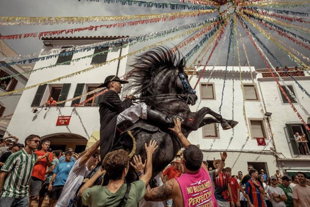 August 24, 2026, Ferreries, Menorca Balearic Islands, Spain: A caixer, or horse rider, rears his horse amid a cheering crowd during the traditional Jaleo at the Sant Bartomeu Festival in Ferreries. Ferreries Spain - ZUMAo105 20260824_fap_o105_023 Copyright: xMatthiasxOesterlex