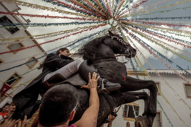 August 24, 2026, Ferreries, Menorca Balearic Islands, Spain: A caixer, or horse rider, rears his horse amid a cheering crowd during the traditional Jaleo at the Sant Bartomeu Festival in Ferreries. Ferreries Spain - ZUMAo105 20260824_fap_o105_024 Copyright: xMatthiasxOesterlex