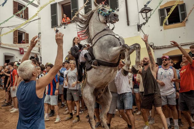 August 24, 2026, Ferreries, Menorca Balearic Islands, Spain: A caixer, or horse rider, rears his horse amid a cheering crowd during the traditional Jaleo at the Sant Bartomeu Festival in Ferreries. Ferreries Spain - ZUMAo105 20260824_fap_o105_032 Copyright: xMatthiasxOesterlex