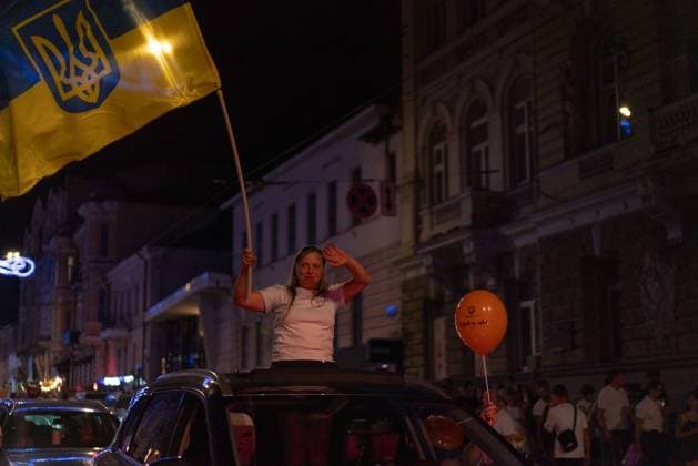August 24, 2026, Kharkiv, Ukraine: KHARKIV, UKRAINE Ã¢â‚¬ AUGUST 23, 2026: People gather in central Kharkiv, Ukraine, on August 23, 2026, to mark Ukrainian National Flag Day, one day ahead of the countryÃ¢â‚¬â ¢s Independence Day. Residents took part in gatherings featuring Ukrainian flags, music, chants and vehicle processions in the northeastern city, which remains exposed to Russian drone and missile attacks amid the continuing war. Kharkiv Ukraine  - ZUMAq101 20260824_zna_q101_084 Copyright: xCarloxBravox