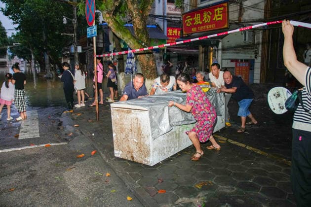 LONGZHOU, CHINA - AUGUST 24: Residents move electrical appliances to avoid flooding in an unaffected area on August 24, 2026 in Longzhou, Guangxi Zhuang Autonomous Region of China. Heavy rainfall brought by Typhoon Zitan and upstream water flow caused water levels in the Zuojiang River section of Longzhou county to rise continuously, submerging parts of the urban area. Local flood control departments are closely monitoring water conditions while rescue operations continue.  Copyright: xChinaxNewsxServicex 111661931425