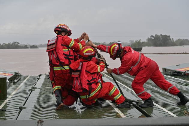 (260825) -- NINGMING, Aug. 25, 2026 -- Rescuers assemble a powered pontoon bridge in Beijiang Township, Ningming County, south China s Guangxi Zhuang Autonomous Region, Aug. 24, 2026. Rescue forces have been deployed in Ningming County where typhoon-triggered heavy rainfall caused flood. A powered pontoon bridge was deployed for emergency rescue operations on Monday. ) CHINA-GUANGXI-HEAVY RAINFALL-RESPONSE (CN) ZhouxHua 
