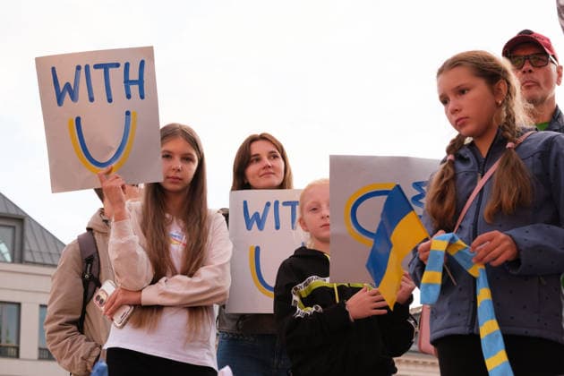 August 24, 2026, Warsaw, Masovian Voivodeship, Poland: Demonstrators hold Ukraine solidarity placards that read with U during celebrations of Ukraine s 35th Independence Day in Warsaw, Poland. The event was organized by Ukrainian diaspora organizations and Polish activist groups in solidarity with Ukraine during a time of heightened tensions between Poles and Ukrainian migrants, with recent acts of xenophobic, anti-Ukrainian violence being incited by Polish far-right groups and politicians. Warsaw Poland - ZUMAk204 20260824_zip_k204_006 Copyright: xRomanxKozielx