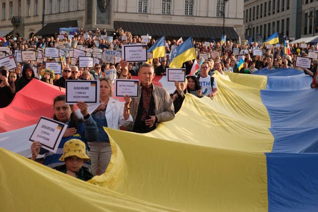 August 24, 2026, Warsaw, Masovian Voivodeship, Poland: People hold up placards with the names of Ukrainians killed in Russian attacks as others hold giant Ukrainian and Polish flags during celebrations of Ukraine s 35th Independence Day in Warsaw, Poland. The event was organized by Ukrainian diaspora organizations and Polish activist groups in solidarity with Ukraine during a time of heightened tensions between Poles and Ukrainian migrants, with recent acts of xenophobic, anti-Ukrainian violence being incited by Polish far-right groups and politicians. Warsaw Poland - ZUMAk204 20260824_zip_k204_050 Copyright: xRomanxKozielx