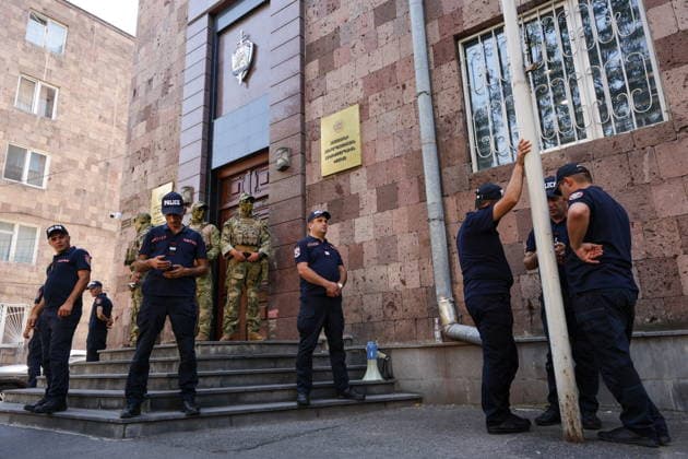 ARMENIA, YEREVAN - AUGUST 25, 2026: Law enforcement officers are seen outside the building of the Armenian Anti-Corruption Committee. The Armenian Anti-Corruption Committee accuses former Armenian President Robert Kocharyan (1998-2008) of using his official position to acquire property at a price below its market value Yerevan Armenia  - ZUMAt113 20260825_zaa_t113_132 Copyright: xAlexanderxPatrinx