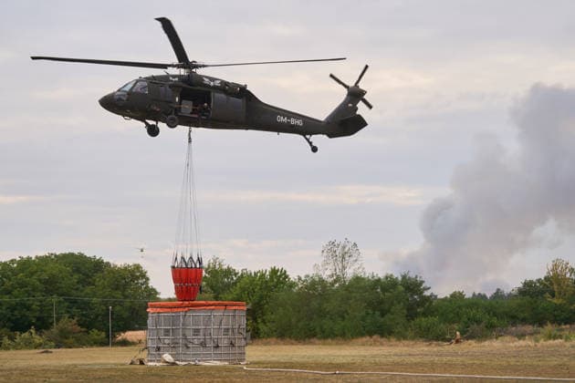 August 25, 2026, Susara, Vojvodina, Serbia: 2026825, Susara, Serbia - Two Sikorsky UH-60 Black Hawk helicopters are deployed to the village of Susara to help battle the severe wildfires devastating the Deliblato Sands (Deliblatska Pescara) Special Nature Reserve, refilling their buckets from a large portable water tank placed on a local football pitch. Susara Serbia  - ZUMAd223 20260825_zip_d223_006 Copyright: xMarkoxDimicx