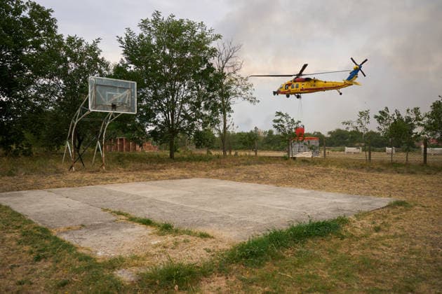 August 25, 2026, Susara, Vojvodina, Serbia: 2026825, Susara, Serbia - Two Sikorsky UH-60 Black Hawk helicopters are deployed to the village of Susara to help battle the severe wildfires devastating the Deliblato Sands (Deliblatska Pescara) Special Nature Reserve, refilling their buckets from a large portable water tank placed on a local football pitch. Susara Serbia - ZUMAd223 20260825_zip_d223_008 Copyright: xMarkoxDimicx