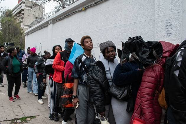 August 25, 2026, Santiago, Chile: SANTIAGO, CHILE, AUGUST 25, 2026: Haitian citizens gather at the Consulate of Haiti in Santiago to complete paperwork related to the regularization of their immigration status in Chile. Santiago Chile  - ZUMAq101 20260825_zna_q101_144 Copyright: xVicentexAsenciox