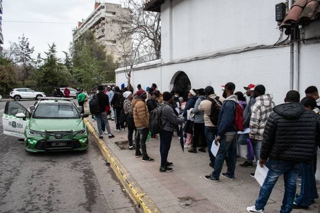 August 25, 2026, Santiago, Chile: SANTIAGO, CHILE, AUGUST 25, 2026: Haitian citizens gather at the Consulate of Haiti in Santiago to complete paperwork related to the regularization of their immigration status in Chile. Santiago Chile  - ZUMAq101 20260825_zna_q101_146 Copyright: xVicentexAsenciox
