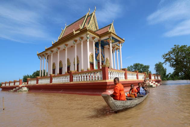 (260826) -- KRATIE, Aug. 26, 2026 -- Monks take a boat through floodwater in Kratie province, Cambodia, Aug. 24, 2026. The flooding of the Mekong River has affected 13,688 families across four Cambodian provinces, forcing 1,551 families to evacuate to higher ground, a disaster control spokesperson said Tuesday. Soth Kim Kolmony, spokesperson for the National Committee for Disaster Management (NCDM), said Kratie, Tboung Khmum, Stung Treng, and Kampong Cham provinces have faced severe flooding since last Friday, triggered by the aftermath of Typhoon Saudel. (Photo by Xinhua) CAMBODIA-KRATIE-MEKONG RIVER-FLOOD Sovannara 