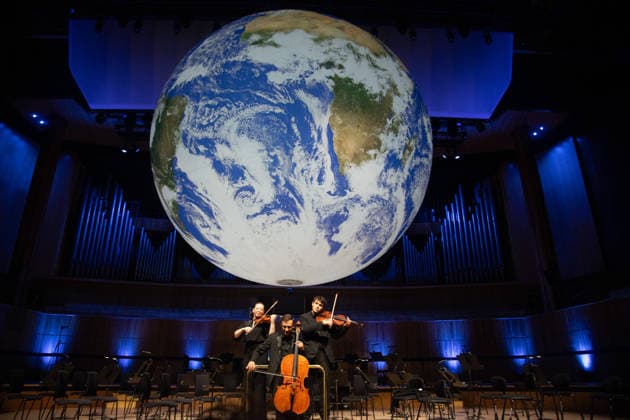 Luke Jerram s Earth Installation GAIA Suspended over Royal Festival Hall Stage at Royal Festival Hall, London, UK - Thursday 27 August 2026 A General view of GAIA by Luke Jerram with members of the BBC Concert Orchestra at Royal Festival Hall, London, England, UK on Thursday 27 August, 2026. The Installation runs from Friday 28th August - 30th August 2026 and Orchestral performances from the BBC Concert Orchestra will take place on Friday 28th and Saturday 29th August 2026., Credit:Justin Ng Avalon UK, England, London, Royal Festival Hall  Copyright: xJustinxNgx xAvalonx 1128810186