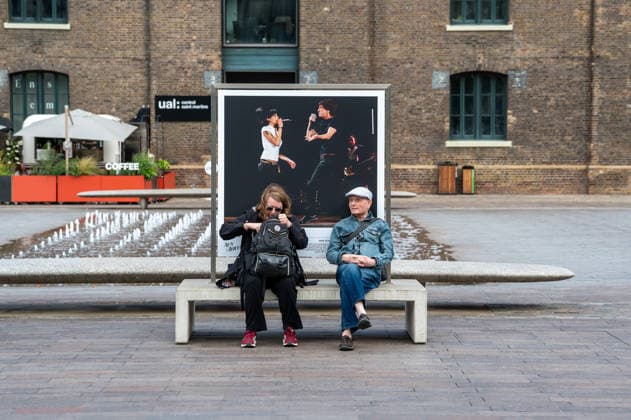 September 9, 2026, London, United Kingdom: Two visitors seen sitting in front of one of the portraits of the late singer in Granary Square, King™s Cross. Visitors view ˜Amy Winehouse: In Focus™, a free outdoor photography exhibition at Granary Square and King™s Boulevard in King™s Cross, London. The exhibition features defining and previously unseen photographs of the late singer, offering an intimate portrait of her life and career and marking 20 years since the release of her acclaimed album ˜Back to Black™. The exhibition runs from 1 September to 15 October 2026. London United Kingdom - ZUMAs197 20260909_aaa_s197_591 Copyright: xJamesxWilloughbyx