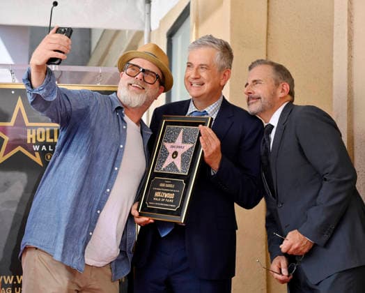 Rainn Wilson (L) and Steve Carell take a selfie with American screenwriter, television producer and director Greg Daniels (holding a replica plaque) during an unveiling ceremony honoring Daniels with the 2,856th star on the Hollywood Walk of Fame in Los Angeles on Thursday, September 10, 2026.  LAP2026091003 JIMxRUYMEN