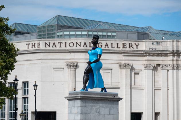 September 12, 2026, London, United Kingdom: Sculpture Lady in Blue with the National Gallery in the background in Trafalgar Square, London. Lady in Blue, a bronze sculpture by New York-based artist Tschabalala Self, stands on the Fourth Plinth in Trafalgar Square, London. Unveiled on 10 September, the work pays homage to a young metropolitan woman of colour and was created as a contemporary everywoman representing the diversity of London today. The sculpture explores themes of representation, recognition and equity, presenting an everyday woman walking forward into a shared future rather than a traditional historical figure or monument. The bronze sculpture is patinated in Lapis Lazuli blue, a pigment with a long history across North - ZUMAs197 20260912_aaa_s197_276 Copyright: xAndreaxDomeniconix