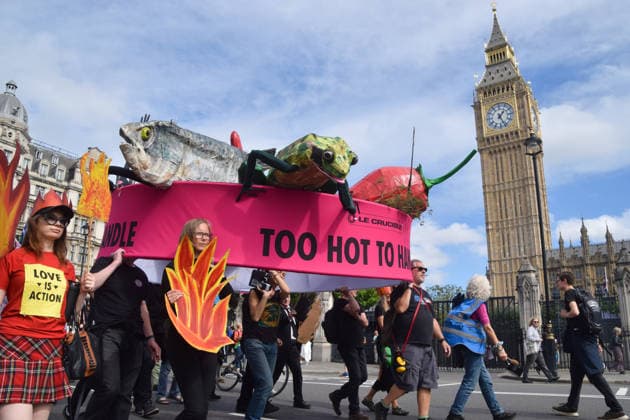 September 14, 2026, London, England, United Kingdom: Extinction Rebellion activists march with a giant casserole in Parliament Square, calling on the government to act on global warming and the climate crisis. London United Kingdom - ZUMAv130 20260914_zip_v130_003 Copyright: xVukxValcicx