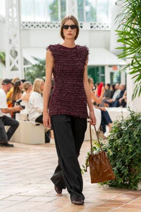 Models present creations from Adolfo Dominguez s Croma collection for spring-summer 2027 during Mercedes-Benz Fashion Week Madrid. Under the creative direction of Tiziana Domínguez, the Galician label, marking its 50th anniversary, remained faithful to its signature codes, showing pronounced asymmetry, scarves worked into both menswear and womenswear, sequins and textile appliques, alongside organic cotton denim dyed in tangerine tones and mini-pleated men s trousers. September 14,2026. (20260914881)
