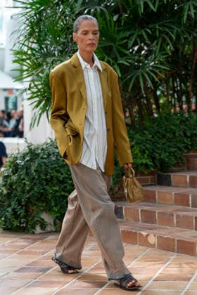 Models present creations from Adolfo Dominguez s Croma collection for spring-summer 2027 during Mercedes-Benz Fashion Week Madrid. Under the creative direction of Tiziana Domínguez, the Galician label, marking its 50th anniversary, remained faithful to its signature codes, showing pronounced asymmetry, scarves worked into both menswear and womenswear, sequins and textile appliques, alongside organic cotton denim dyed in tangerine tones and mini-pleated men s trousers. September 14,2026. (20260914918)