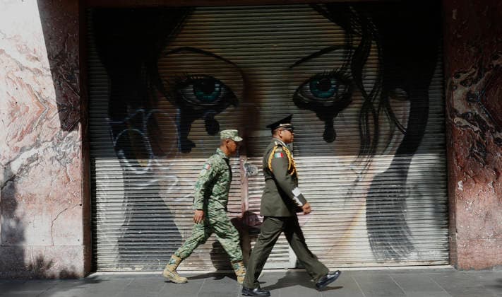 September 16, 2026, Mexico City, Mexico City, mexico: Two members of the Mexican armed forces walk past graffiti during the 216th anniversary of Mexican independence. Mexico City mexico - ZUMAt178 20260916_zip_t178_009 Copyright: xNadiaxTecuapetlax