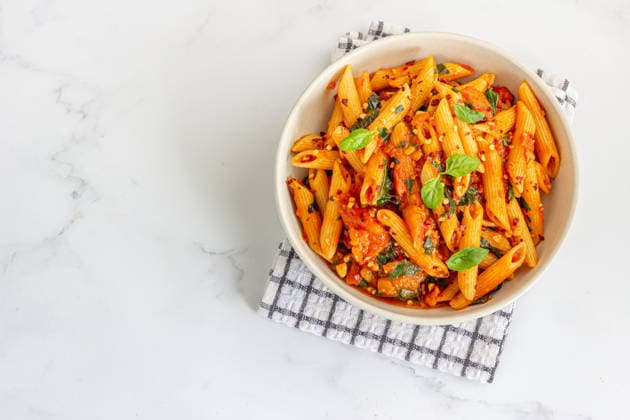 Spicy penne arrabbiata pasta with fresh basil from above Bengaluru, Karnataka, India R_KPBR260920-2123011-01 ,model released, Symbolfoto ,property released