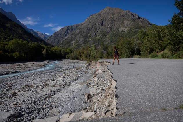 Gyr Flood Damage - France A person stands beside a section of road cut away by the flood along the Gyr. Vallouise-Pelvoux, Hautes-Alpes, France, September 27, 2026. The exceptional floods of August 28 caused major damage in Vallouise-Pelvoux and on the road to Ailefroide. The damage highlights the growing exposure of Alpine valleys to intense rainfall and torrential hazards in a warming climate. Photo by Thibaut Durand ABACAPRESS.COM Vallouise-Pelvoux PROVENCE-ALPES-COTE D AZUR France  Copyright: xDurandxThibaut ABACAx