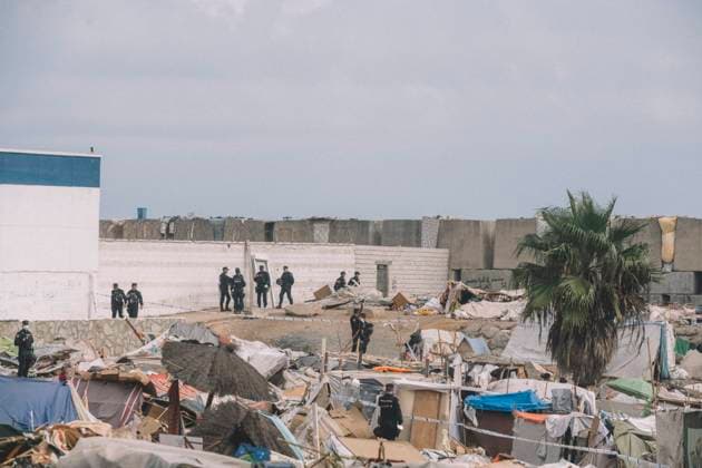 September 27, 2026, Ceuta, Ceuta, Spain: Police officers stand among makeshift shelters at an informal migrant settlement in Ceuta. Thousands of migrants, most of them young Moroccan men, have been living in makeshift settlements in the Spanish North African enclave of Ceuta since a mass arrival at the end of July 2026 set off a migration and political crisis. Ceuta Spain  - ZUMAs392 20260927_zip_s392_004 Copyright: xFabianxSuspensivox
