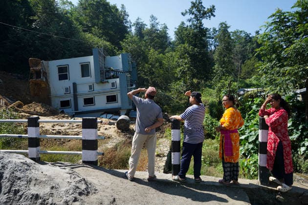 September 28, 2026, Kathmandu, Bagmati, Nepal: People stand and watch near a house that collapsed due to a landslide in Lalitpur, Nepal, on September 28, 2026. Nepal has experienced numerous floods and landslides following continuous rainfall over the past four days. Kathmandu Nepal  - ZUMAd164 20260928_zip_d164_002 Copyright: xAryanxDhimalx