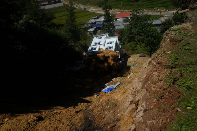September 28, 2026, Kathmandu, Bagmati, Nepal: People stand and watch near a house that collapsed due to a landslide in Lalitpur, Nepal, on September 28, 2026. Nepal has experienced numerous floods and landslides following continuous rainfall over the past four days. Kathmandu Nepal  - ZUMAd164 20260928_zip_d164_003 Copyright: xAryanxDhimalx