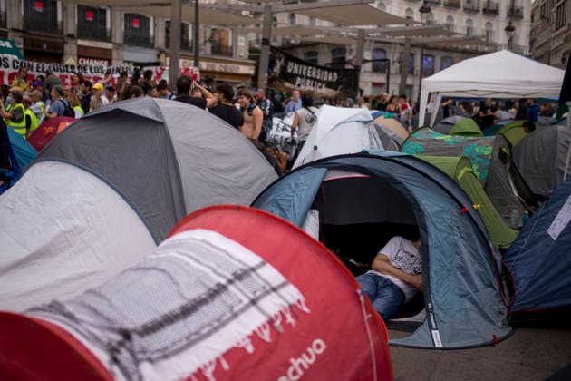 September 28, 2026, Madrid, Madrid, Spain: A young man with his mobile phone in hand sits inside his tent in the Puerta del Sol square in central Madrid, during a protest camp against the high cost of housing and rent in Spain. The protest arose following the eviction of an 87-year-old woman from her apartment in Madrid. Madrid Spain  - ZUMAs296 20260928_znp_s296_004 Copyright: xLuisxSotox
