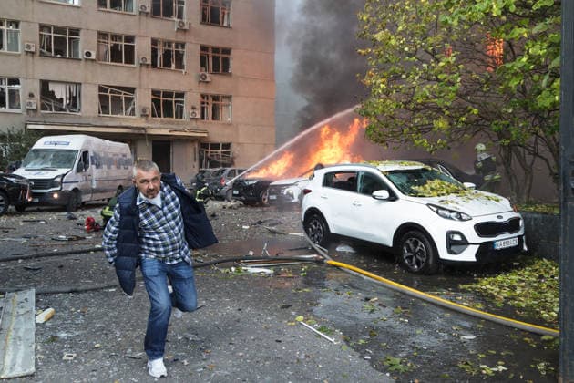 A man walks past rescuers pouring water on burning cars and the National Academy of Sciences building in Kyiv, Ukraine, September 28, 2026. One person was killed, and three others were injured in the attack. (Photo by Kyrylo Chubotin Ukrinform) Russian drone strikes Ukrainian National Academy of Sciences building in KyivRussian drone strikes Ukrainian National Academy of Sciences building in Kyiv  Copyright: xKirillxChubotinx