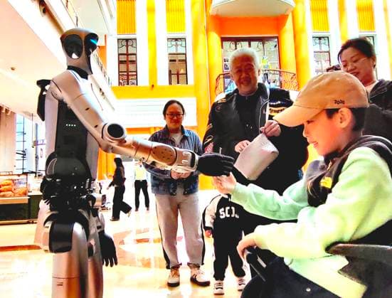 HARBIN, CHINA - SEPTEMBER 29: An AI humanoid robot interacts with customers at a shopping mall on September 29, 2026 in Harbin, Heilongjiang Province of China. The robot, brought by a technology company located in the mall, can communicate via voice and perform actions such as shaking hands, waving, making heart gestures and dancing.  Copyright: xVCGx 111670495815