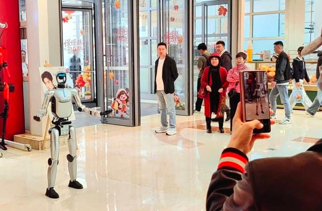 HARBIN, CHINA - JANUARY 29: A humanoid robot interacts with customers at a shopping mall on January 29 in Harbin, Heilongjiang Province of China. The robot features flexible limb movements and can perform actions such as dancing, shaking hands, waving, making heart gestures, and engaging in voice communication.  Copyright: xVCGx 111670495820