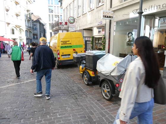 29.09.2026 Schweiz. Bild . Postzustellung mit Lieferwagen 100 Prozent Electric und ein elektrischen Dreiradroller.