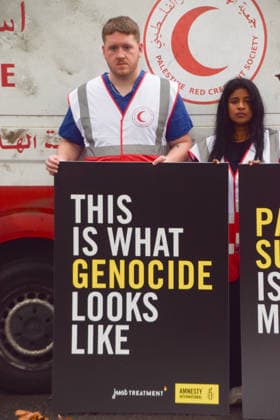September 30, 2026, London, England, United Kingdom: Healthcare professionals stand with placards next to a van made to look like a heavily damaged Gaza ambulance as Amnesty International UK and Just Treatment stage a protest outside Palantir headquarters in Soho Square. The campaigners are calling on the UK Government not to extend its NHS contract with the US tech company. London United Kingdom - ZUMAv130 20260930_zip_v130_012 Copyright: xVukxValcicx
